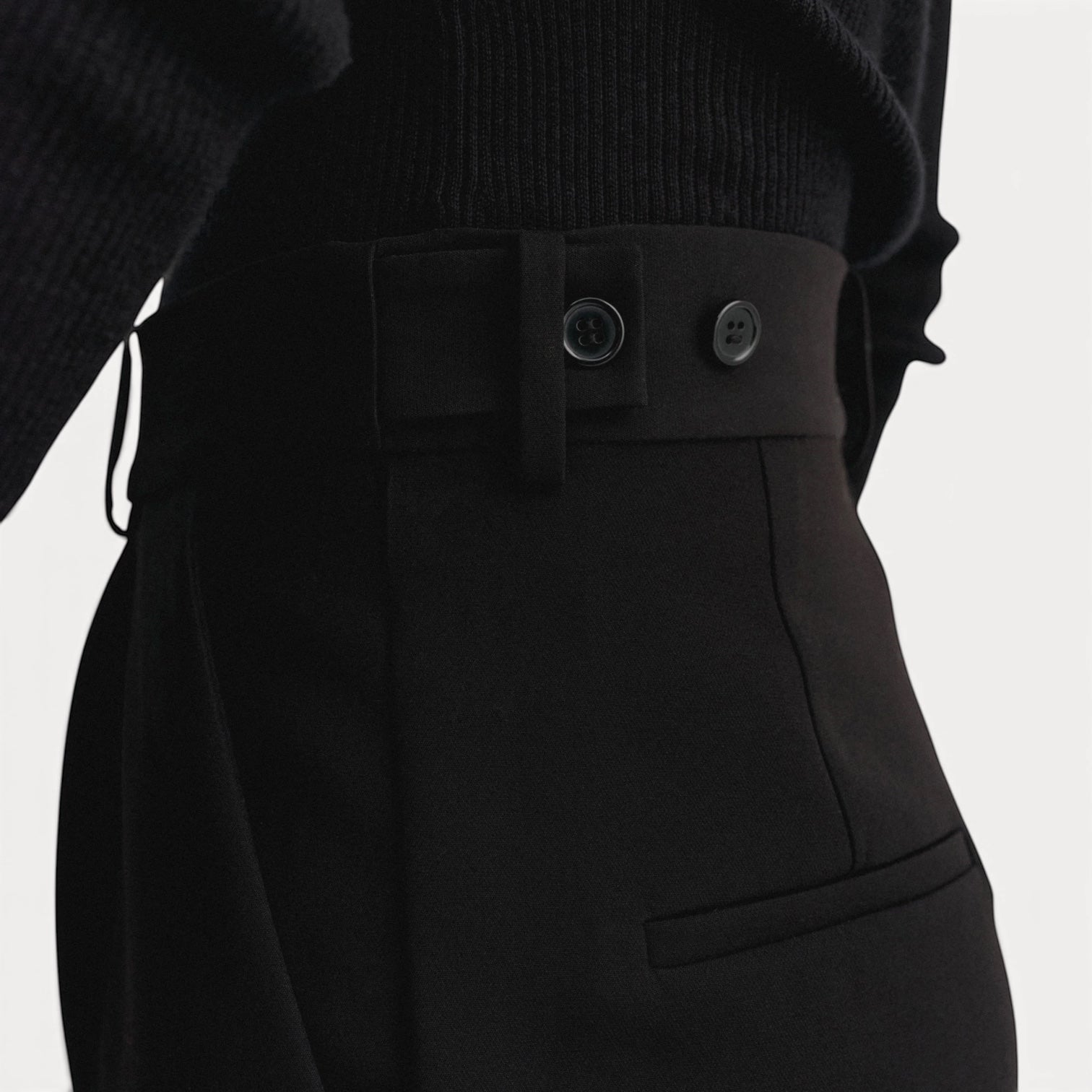 Lula Studio Prague black crepe shorts with high-rise fit, architectural pleats, and button detail.