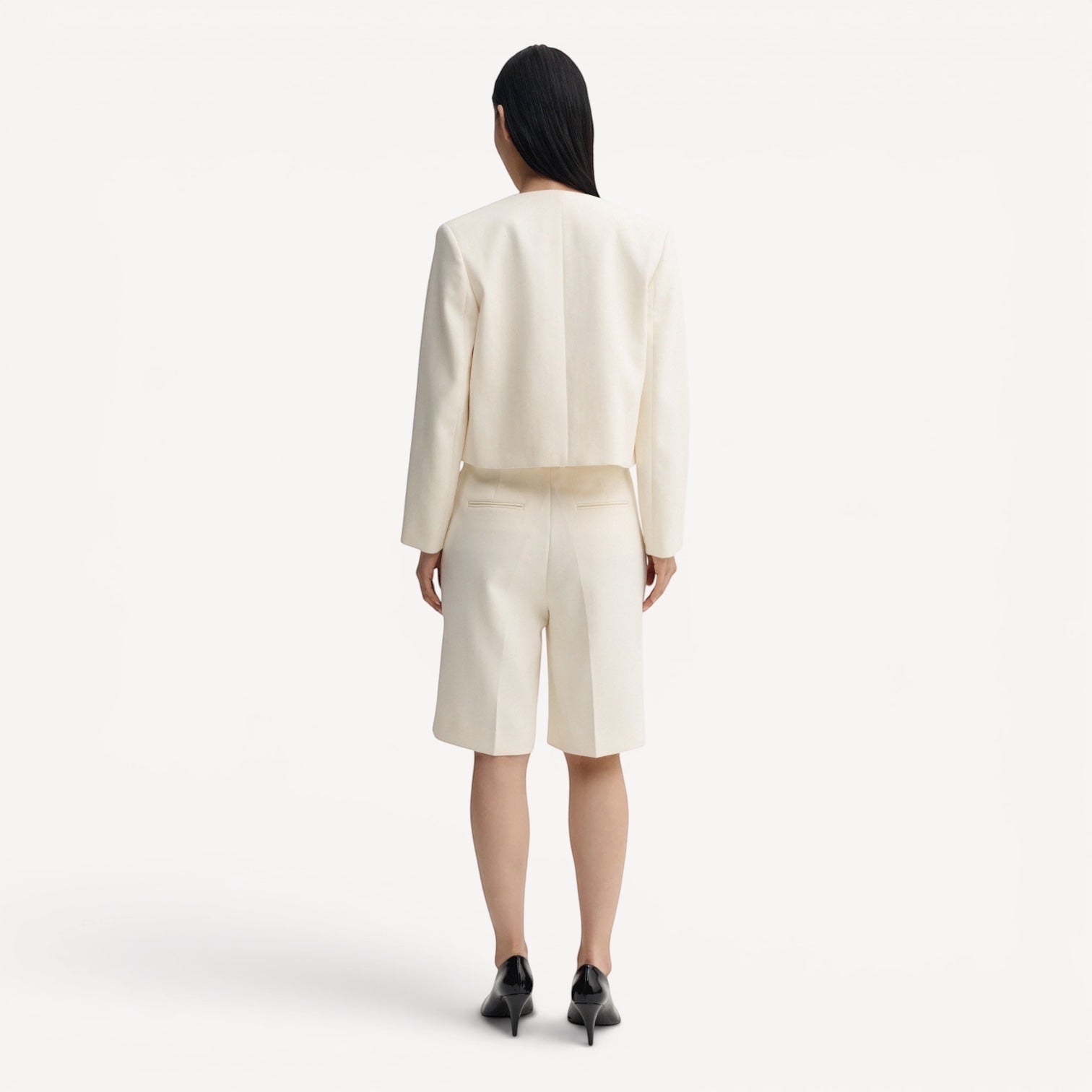 Lula Studio Prague cream woven blend tailored shorts with front pleats and adjustable side tabs.