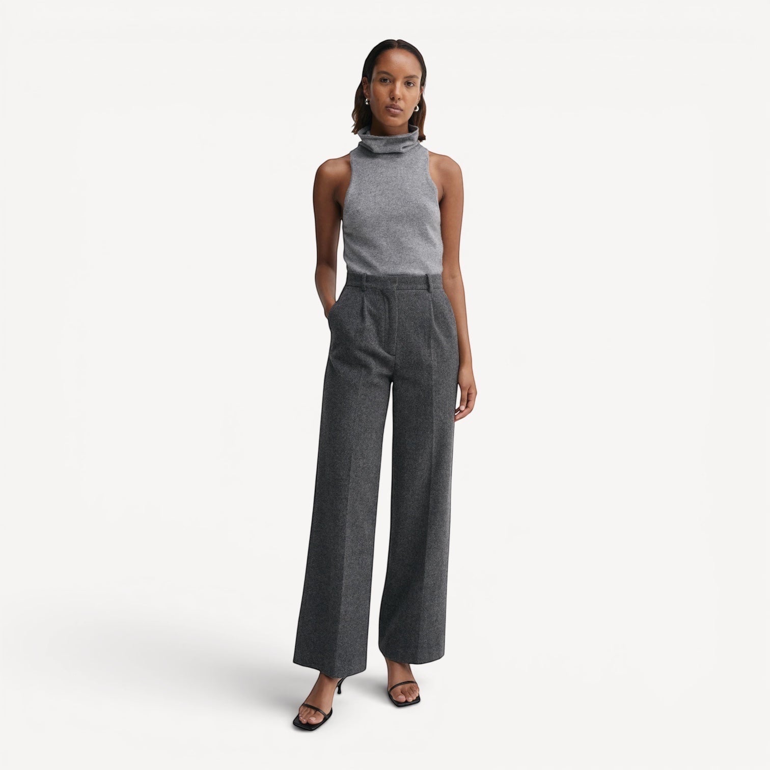 Lula Studio Prague grey sleeveless cashmere turtleneck top with a racerback, paired with wide-leg grey trousers.